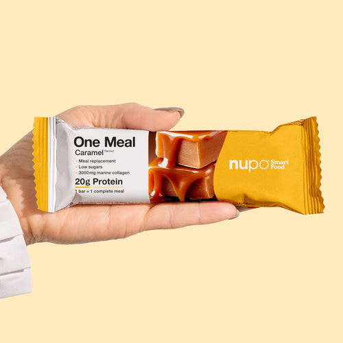Nupo One Meal Bar Caramel Riegel in der Hand